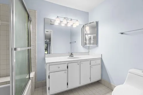 a bathroom with a sink a vanity and a mirror
