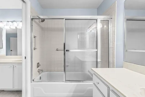 a bathroom with a double vanity sink and mirror
