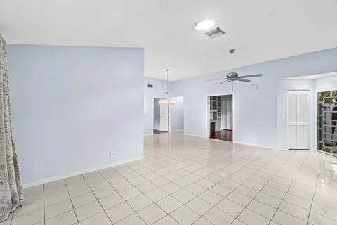 a view of an empty room with a ceiling fan