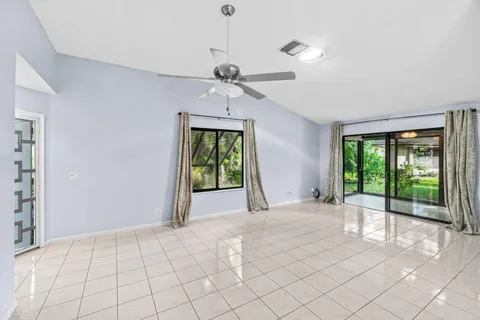 a view of an empty room with a ceiling fan
