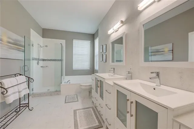 a spacious bathroom with a double vanity sink mirror and bathtub