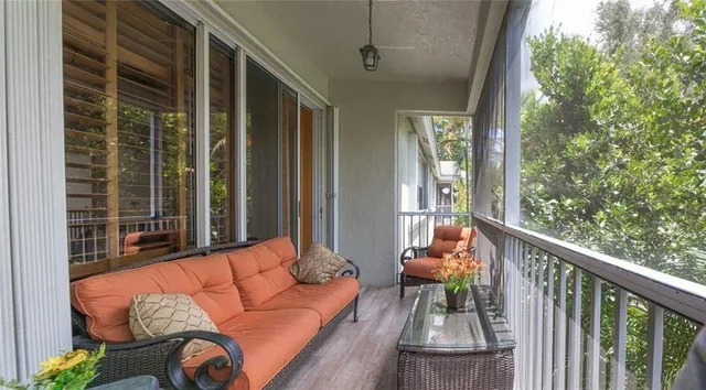 a balcony with furniture and wooden floor