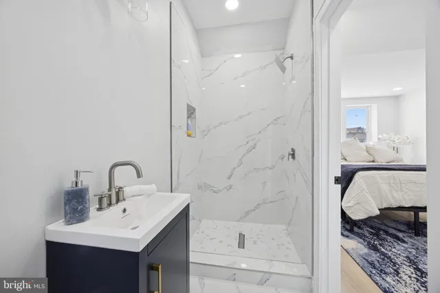 a bathroom with a sink a toilet and shower