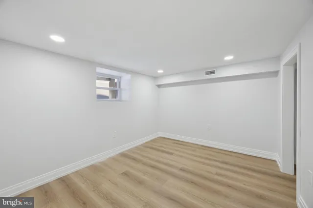 a view of room with wooden floor and fan