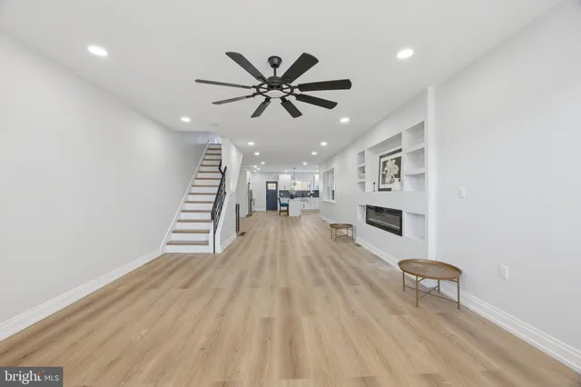 a view of a living room hardwood floor and a ceiling fan