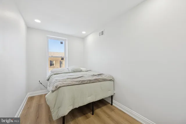 a bedroom with a bed and a night stand