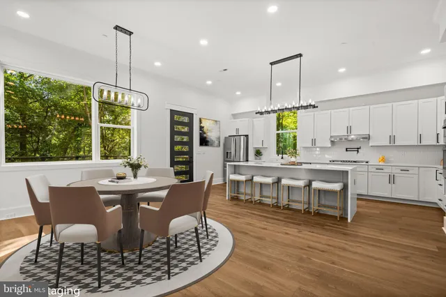 a living room with lots of white furniture and a chandelier