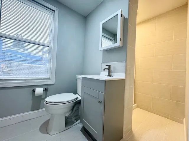 a bathroom with a sink toilet and mirror