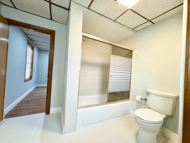 a bathroom with a toilet and a shower