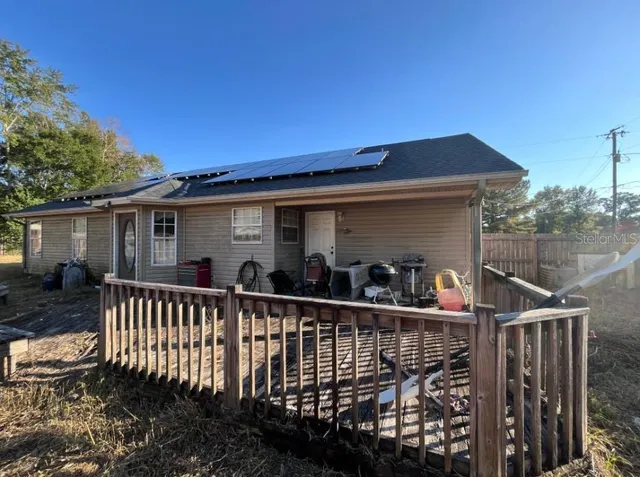 a view of a house with wooden deck