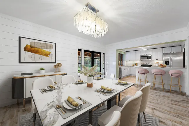 a view of a dining room with furniture a chandelier and wooden floor
