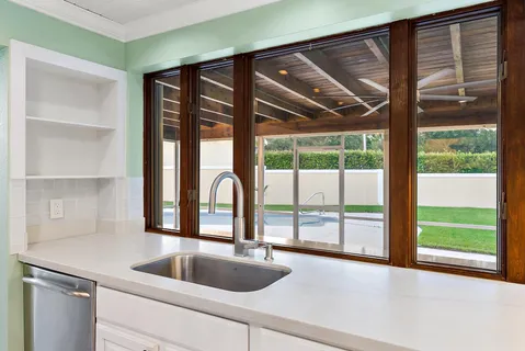 a kitchen with a sink and large window