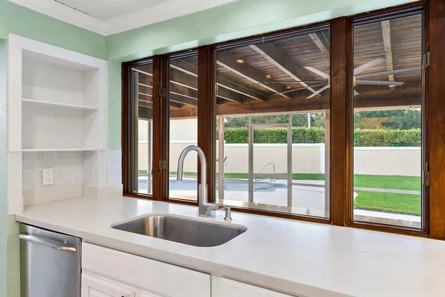 a kitchen with a sink and large window