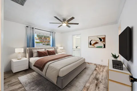 a bedroom with a bed and a flat screen tv