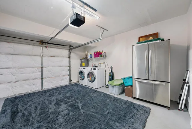 a utility room with refrigerator and microwave