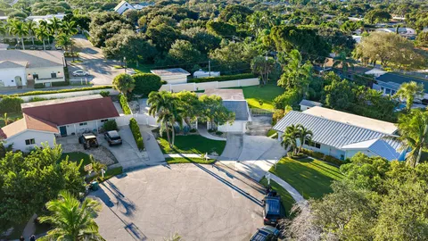 an aerial view of a house with yard swimming pool and outdoor seating