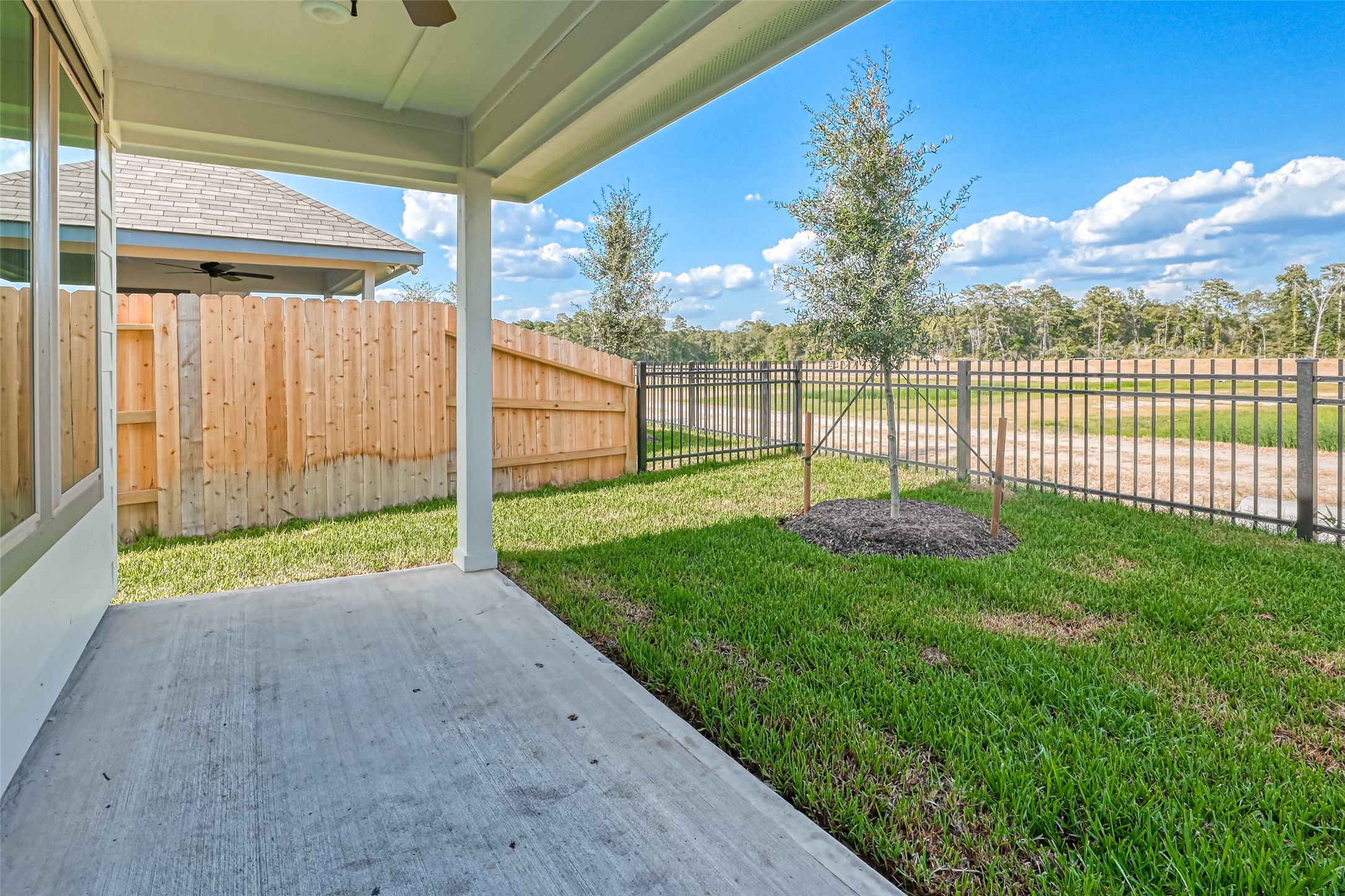 3106 Rising Fir Lane Conroe, TX 77385 - Photo 27 of 32 a view of a yard with wooden fence