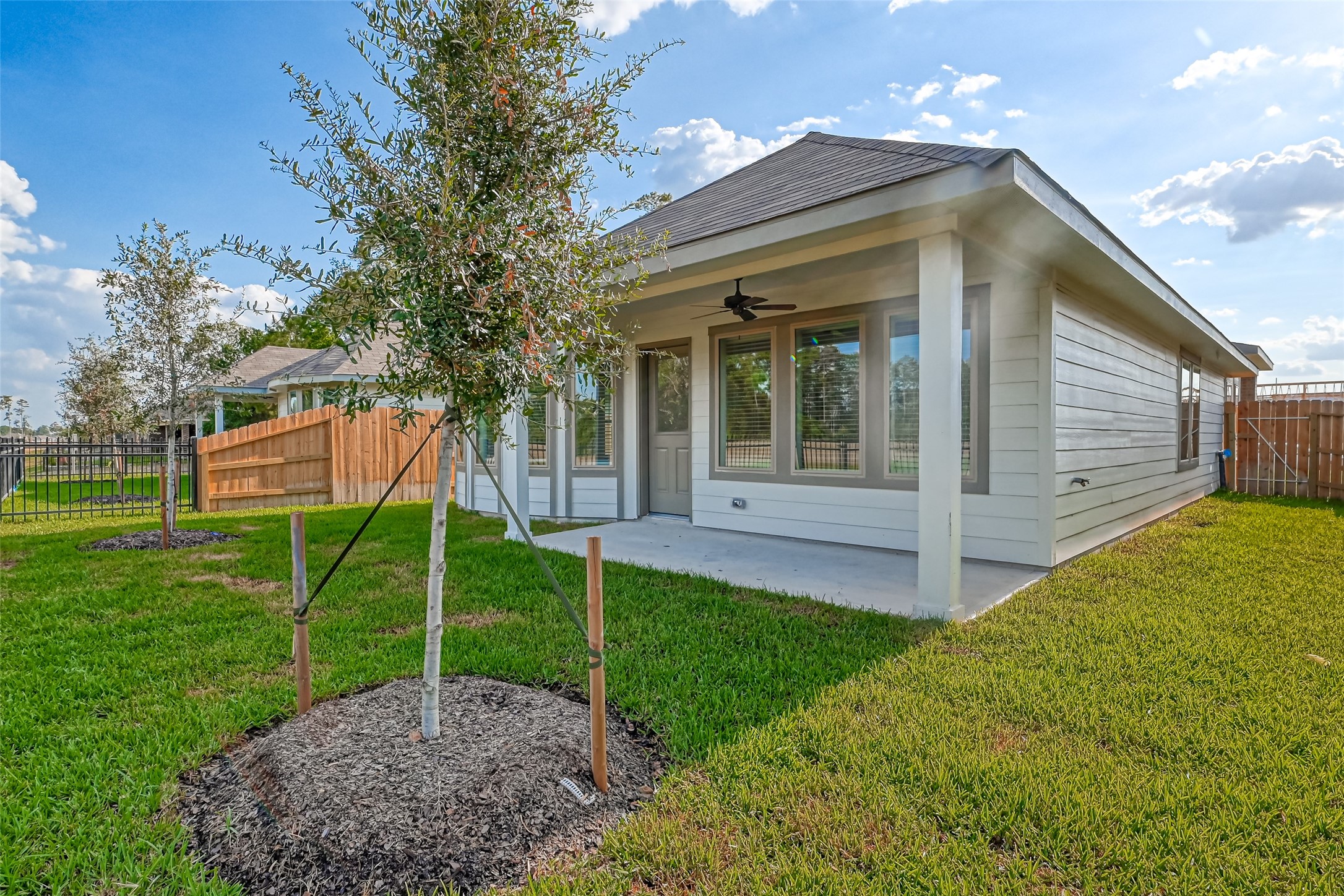 3106 Rising Fir Lane Conroe, TX 77385 - Photo 30 of 32 a view of a house with backyard and garden