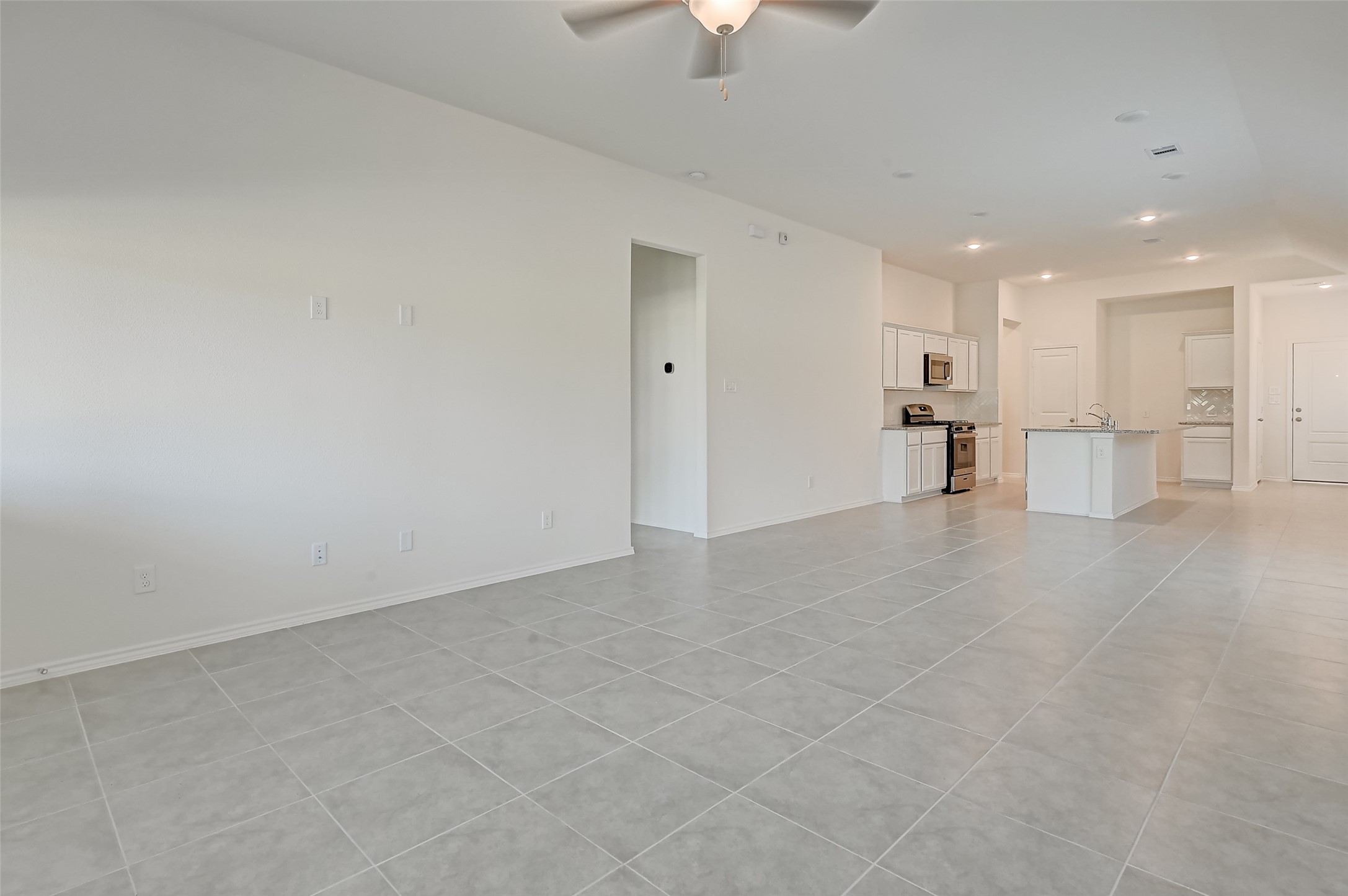 3106 Rising Fir Lane Conroe, TX 77385 - Photo 6 of 32 a view of an empty room with a kitchen