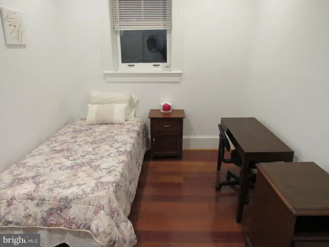 a bedroom with a bed and a dresser in it