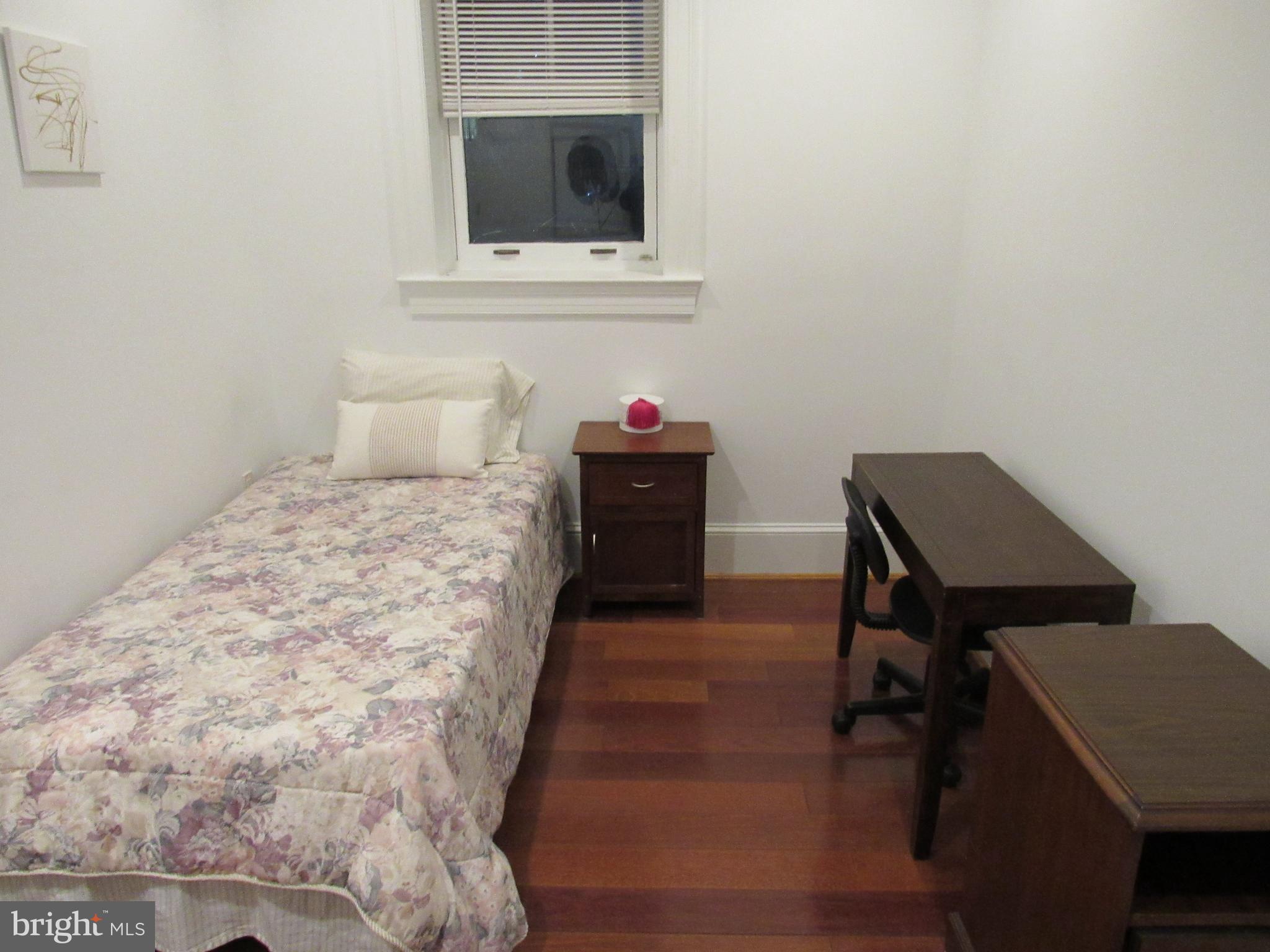 936 Madison Street Northwest, Unit 103 Washington, DC 20011 - Photo 20 of 23 a bedroom with a bed and a dresser in it