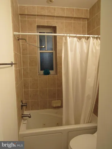a bathroom with a shower and a bath tub