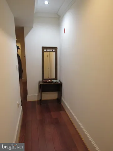 a view of a room with wooden floor