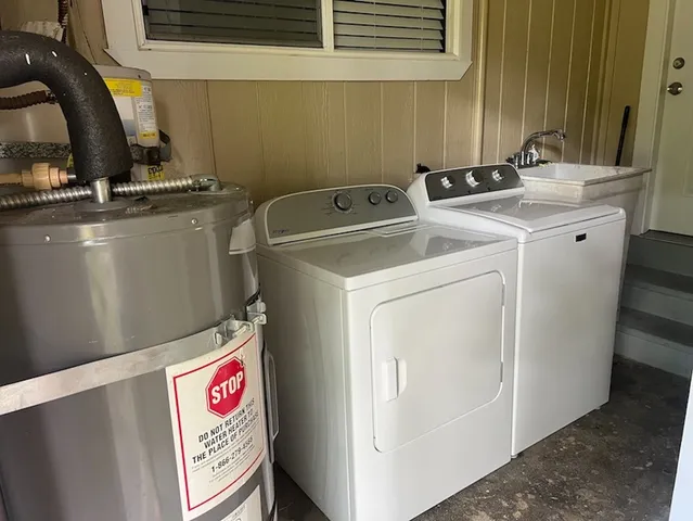 a kitchen with granite countertop wooden cabinets and a refrigerator