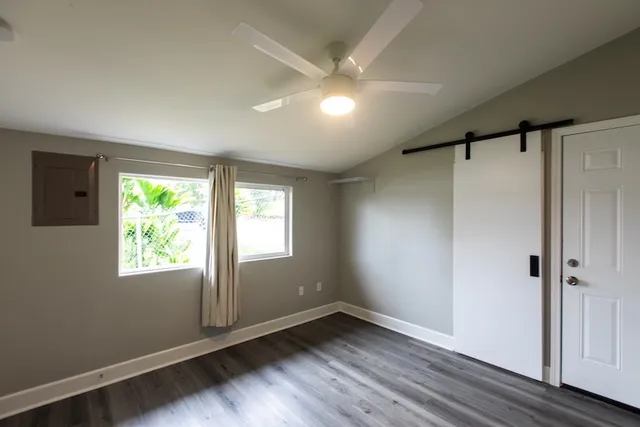 a view of an empty room with wooden floor