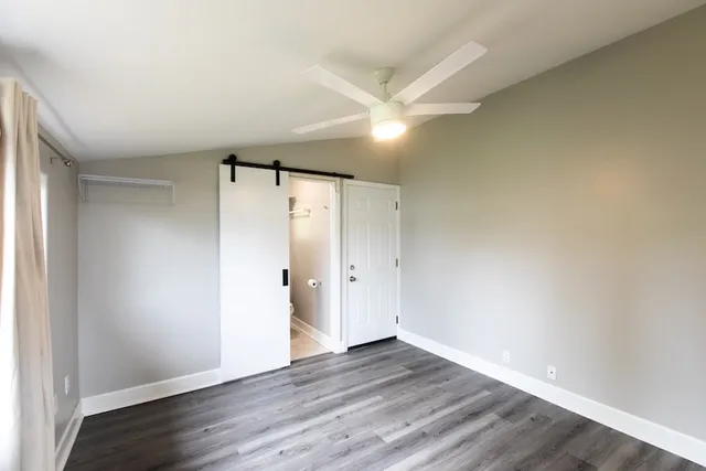a view of a house with backyard and a car parked in front of it