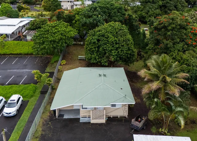 an aerial view of city lake and trees
