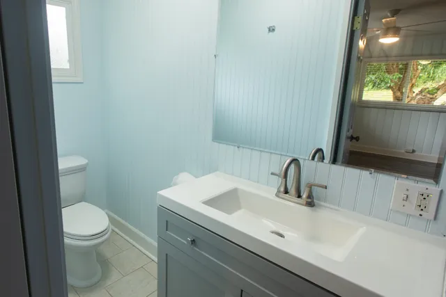 a view of empty room with wooden floor and window