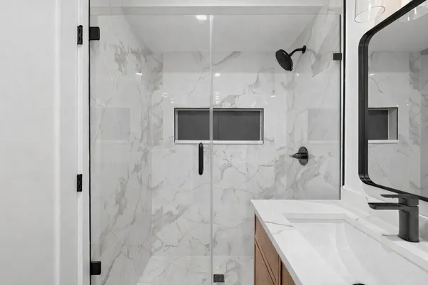 a bathroom with a sink toilet and shower