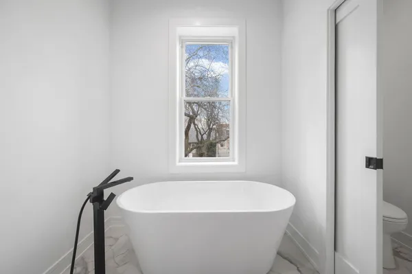 a white bath tub sitting in a bathroom