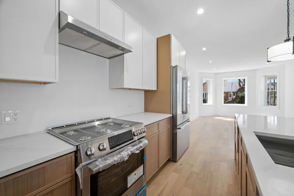 a kitchen with a stove and a refrigerator