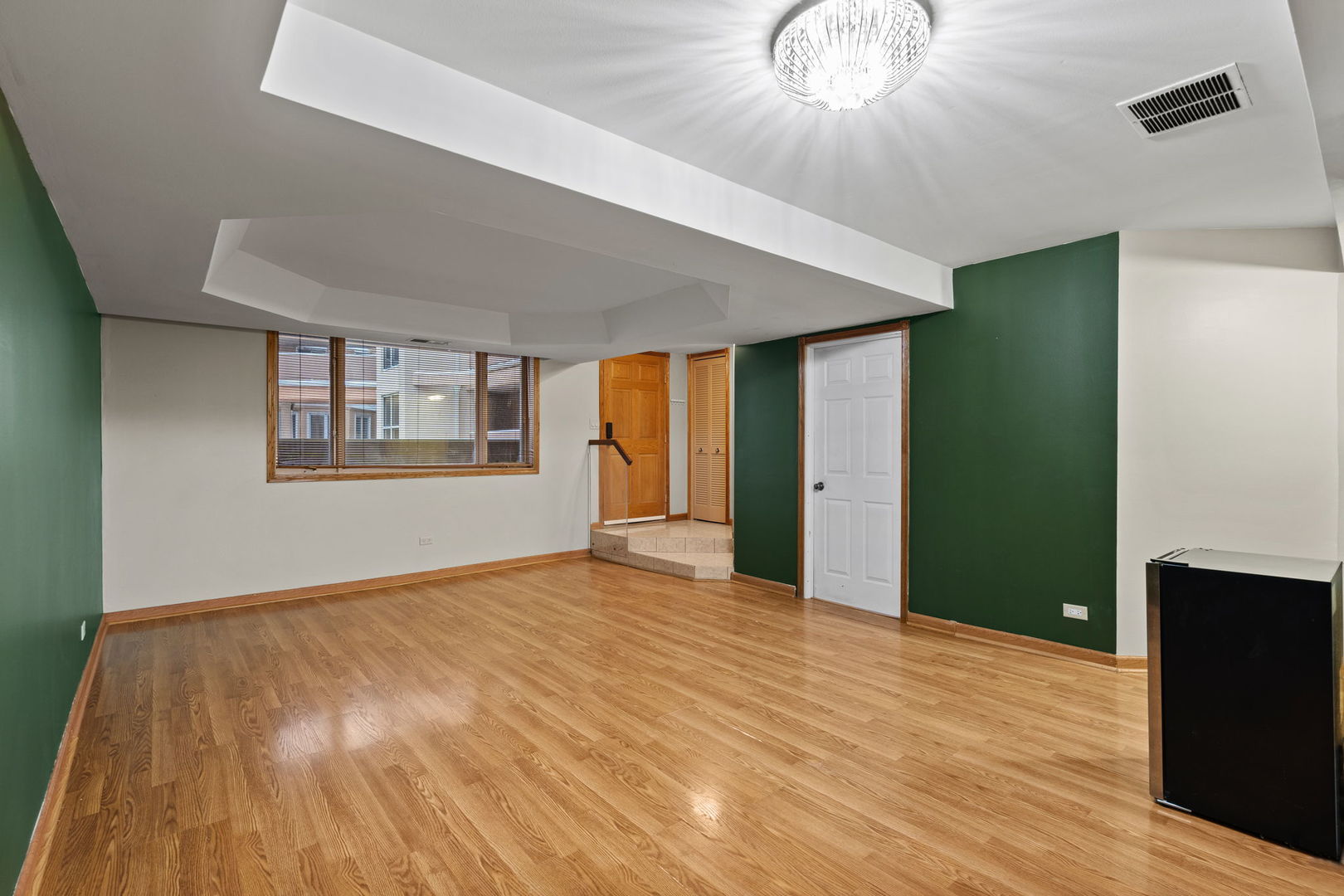 6337 Roosevelt Road, Unit 208 Berwyn, IL 60402 - Photo 3 of 14 a view of an empty room with wooden floor and a window
