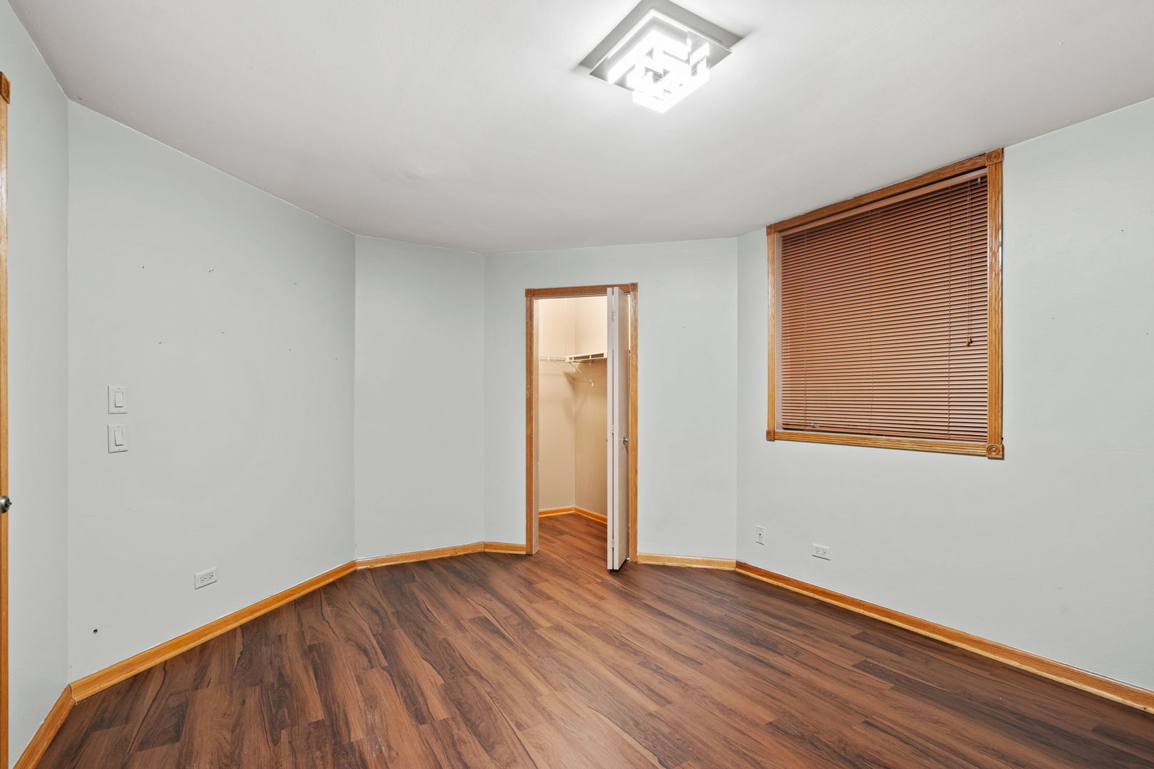 6337 Roosevelt Road, Unit 208 Berwyn, IL 60402 - Photo 8 of 14 an empty room with wooden floor and windows