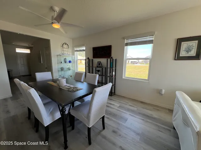 a view of a dining room with furniture and window