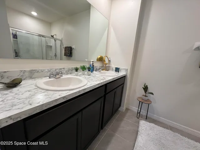 a spacious bathroom with a granite countertop sink a toilet and a mirror