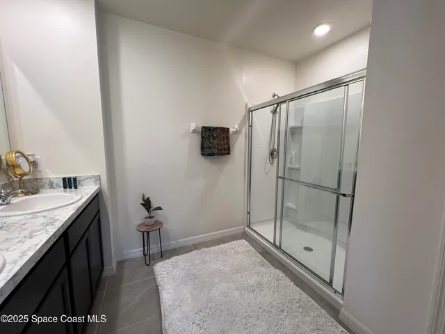 a bathroom with a double vanity sink toilet and shower