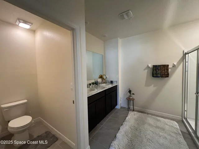 a living room with furniture a ceiling fan and a window