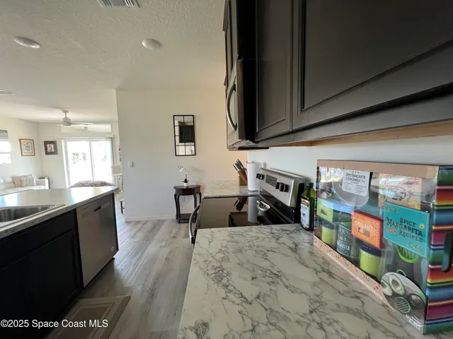 a kitchen with sink stove and cabinets