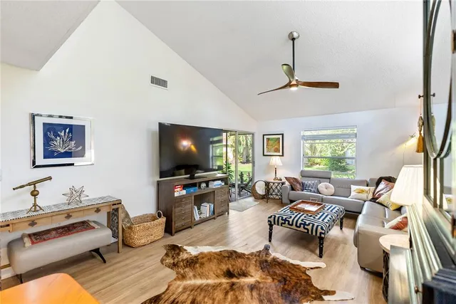 a living room with dining room and wooden floor