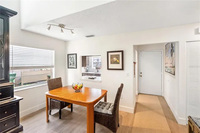 a living room with furniture a chandelier and a window