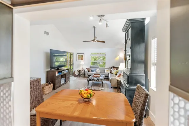 a view of living room with furniture and wooden floor