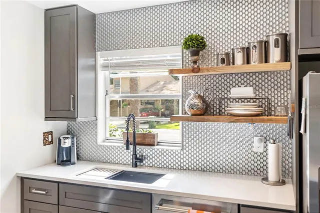 a kitchen with stainless steel appliances a stove a sink and a refrigerator