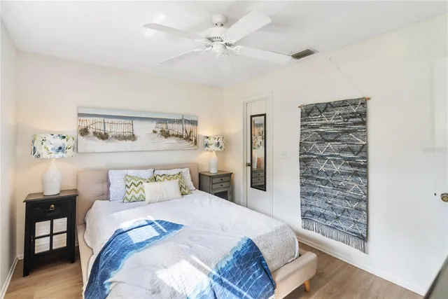 a bathroom with a sink a toilet a mirror and shower