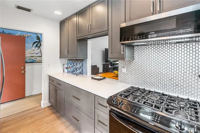a kitchen with stainless steel appliances granite countertop a refrigerator sink and stove