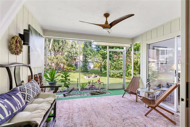 a view of a backyard with table and chairs and potted plants