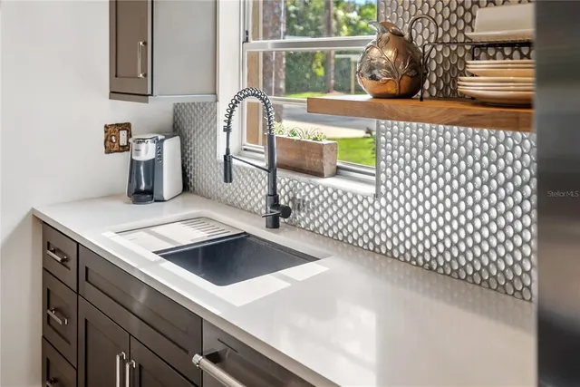a kitchen that has a sink and a stove in it
